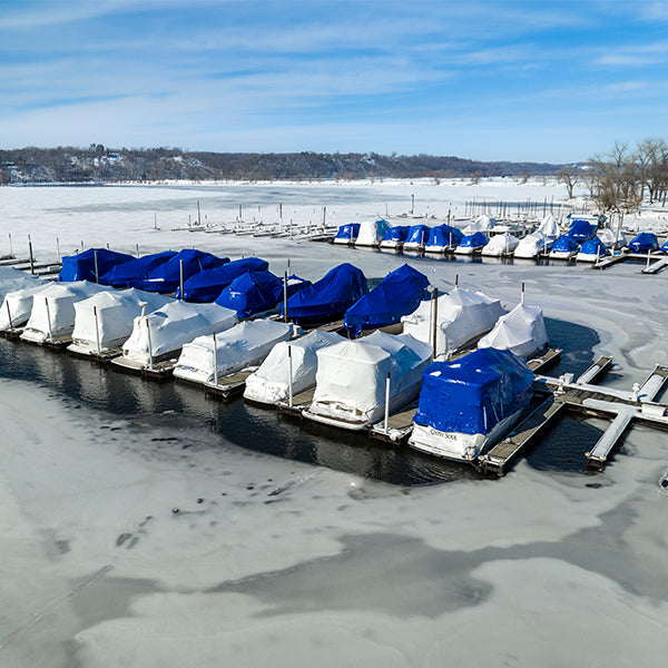 Winter marina with open water around covered boats protected by Kasco de-icers