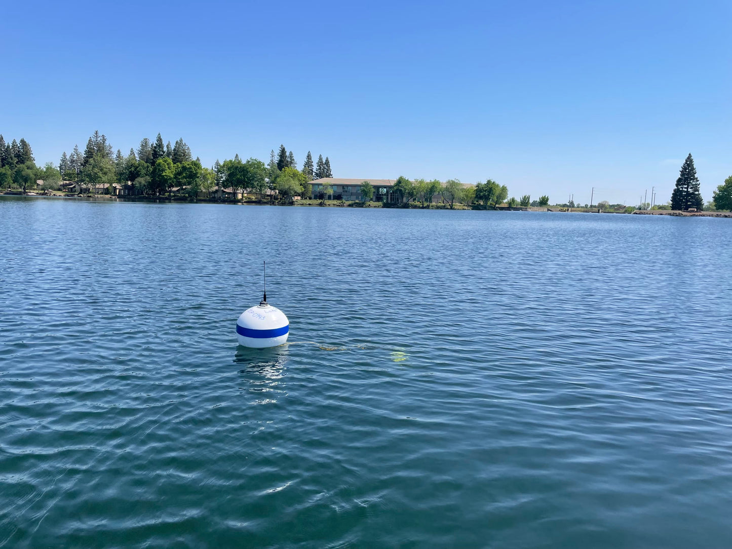 LakeTech monitoring buoy deployed in blue lake water